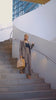 professional women carrying laptop bag down spiral staircase
