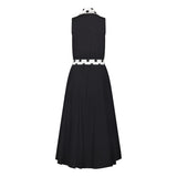 Ghost image, back view of black fit and flare polka dot midi dress.  Collar and belt is white with black polka dots and main dress is all black with white buttons on centre front. 